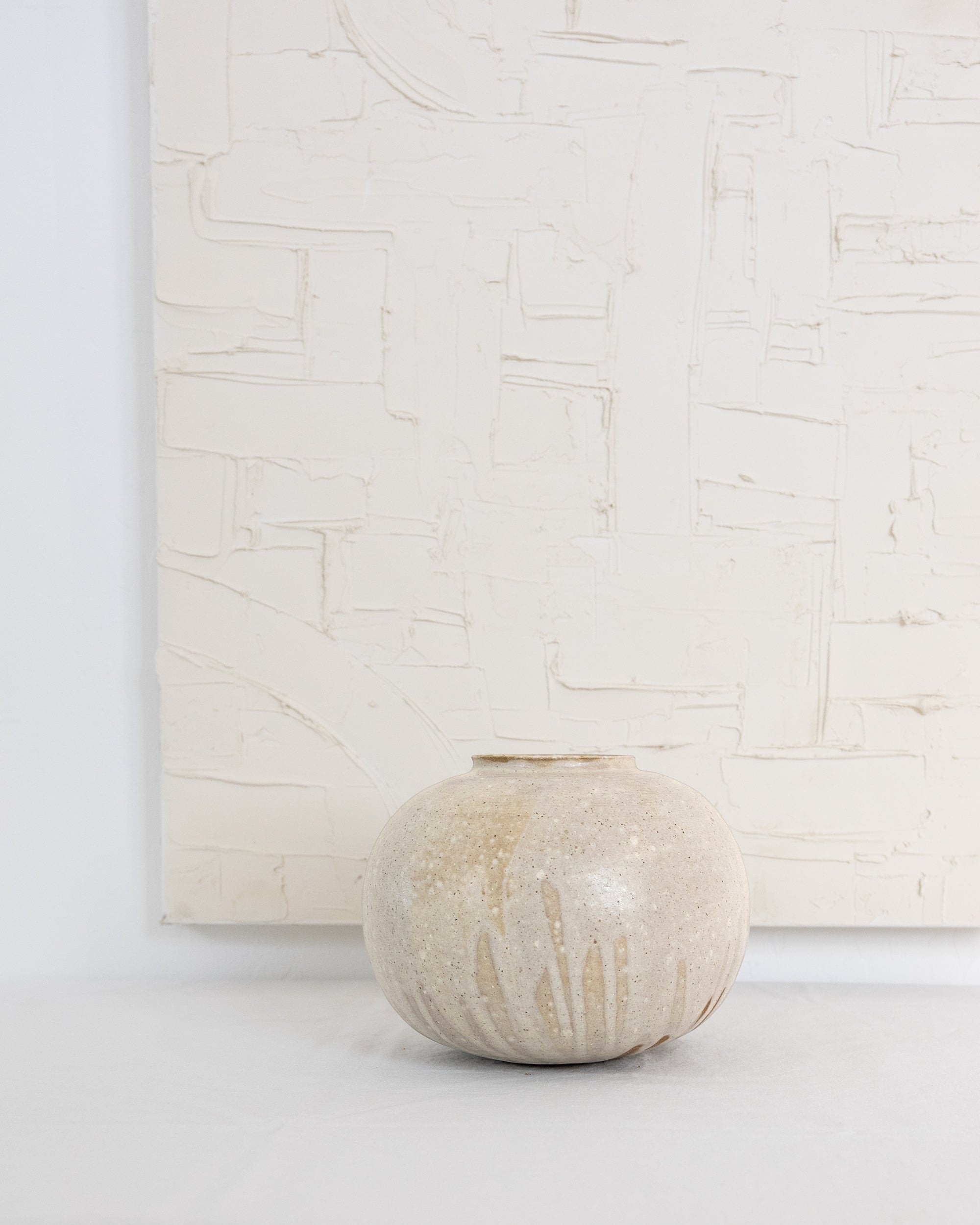 JONES + CO Vase No. 7, a handthrown ceramic vase with a speckled beige glaze and rounded sculptural shape.