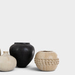 JONES + CO handthrown ceramic vases in black and beige with textured patterns on a white background