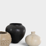 JONES + CO handthrown ceramic vases in black and cream, featuring unique textures and sculptural silhouettes.