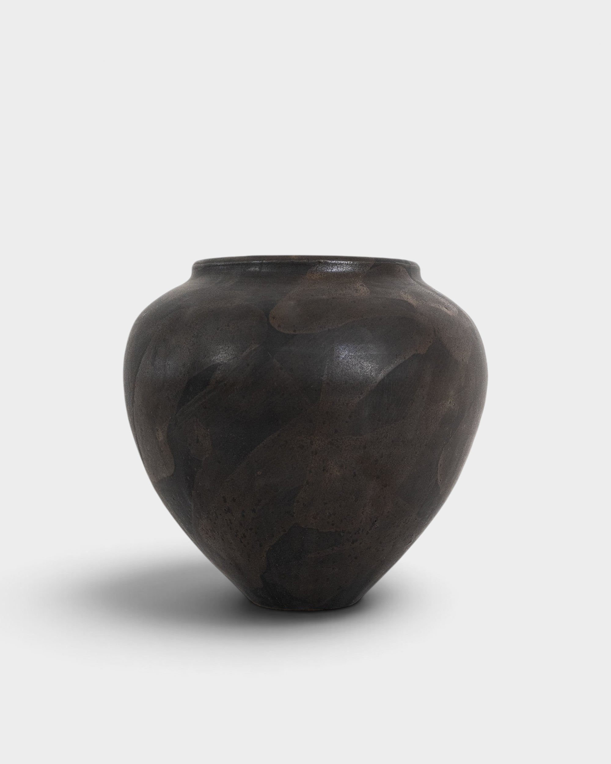 JONES + CO handthrown ceramic vase in dark charcoal with a unique mottled finish and sculptural silhouette.