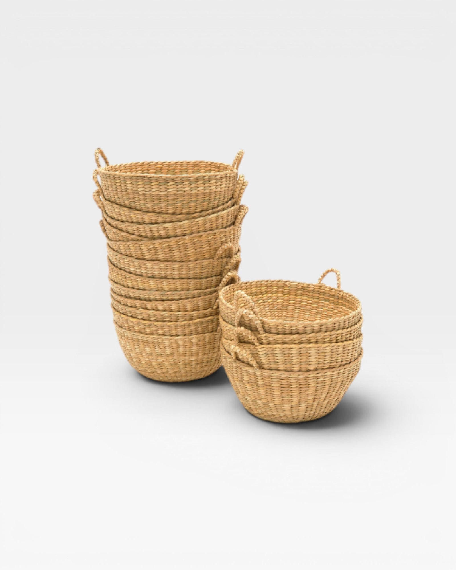JONES + CO handwoven natural junco petite baskets with handles, ideal for decorative storage or catchalls.
