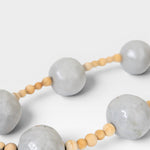JONES + CO handcrafted wall art with large grey pottery beads and small wooden beads, bringing spiritual elegance to any space.