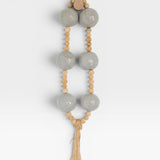 JONES + CO grey pottery and wood hanging wall mala beads with tassel.