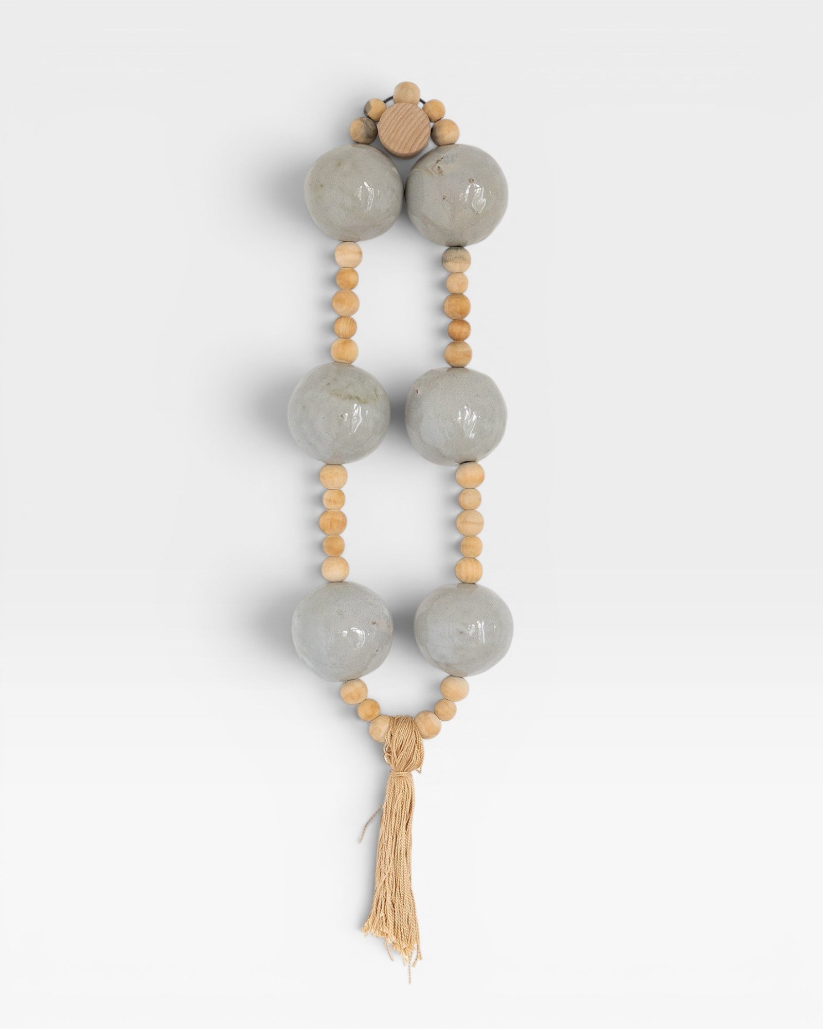 JONES + CO grey pottery and wood hanging wall mala beads with tassel.