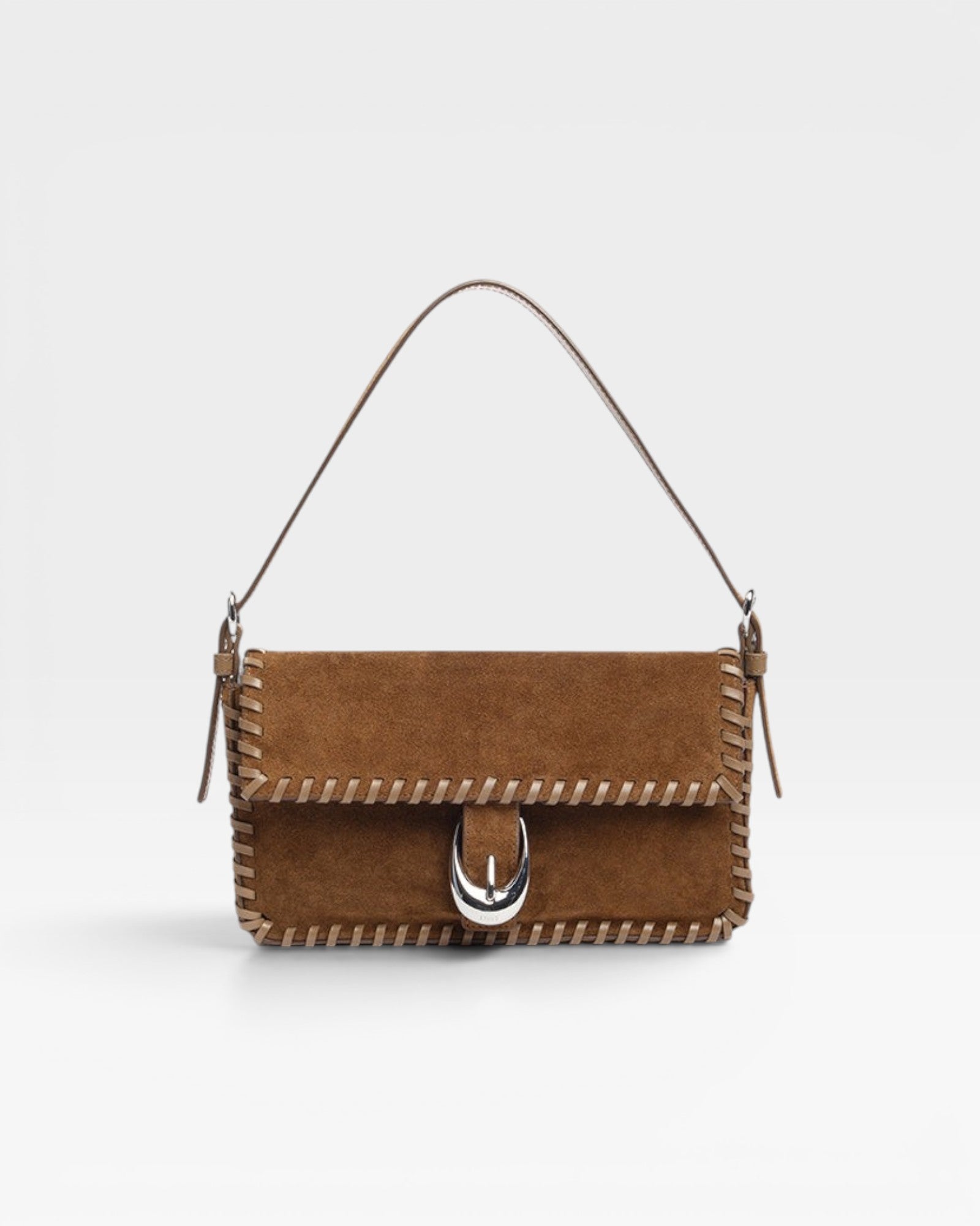 JONES + CO Harlow shoulder bag in cigar brown suede with whipstitch trim and signature silver Moon buckle hardware.