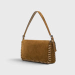 JONES + CO Harlow shoulder bag in cigar brown suede with leather whipstitch detailing and a silver buckle.
