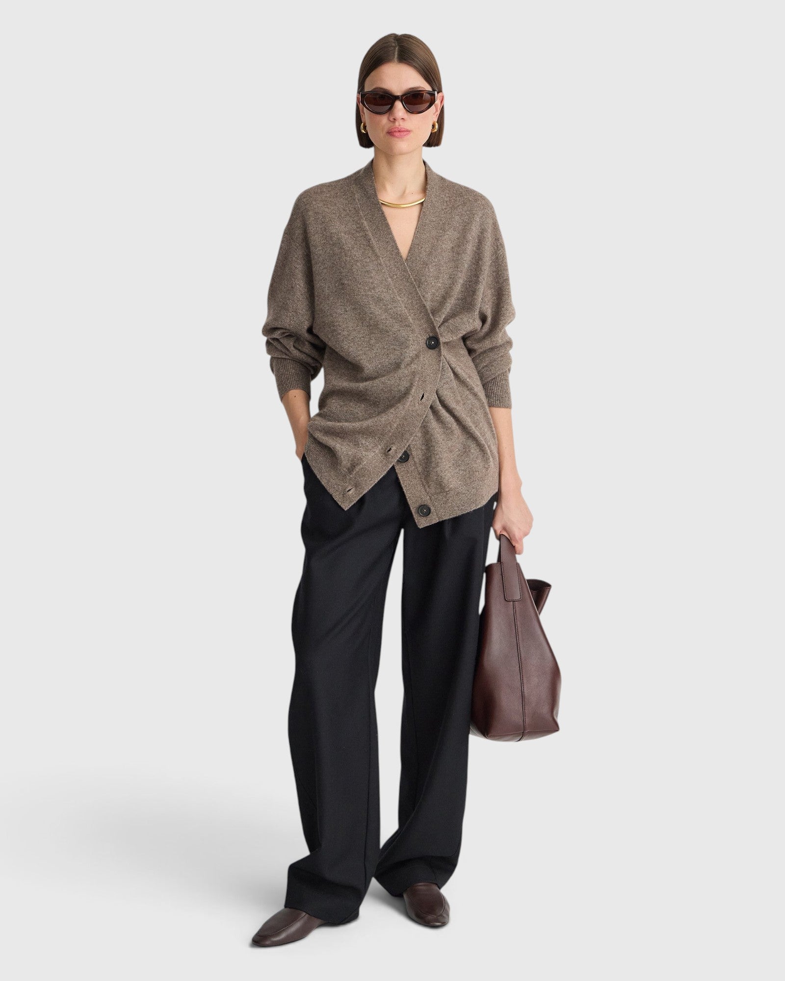JONES + CO hazelnut cashmere-silk cardigan with draped button detail worn by a model with black trousers and bag
