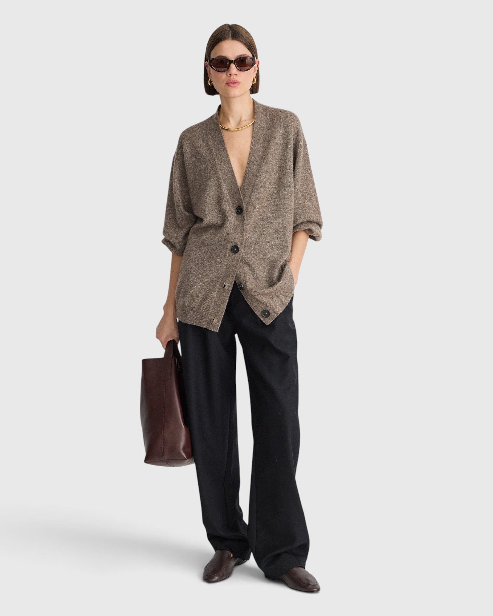 JONES + CO hazelnut cashmere-silk V-neck cardigan with drop shoulders worn by a model with black trousers and a bag