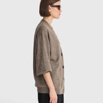 JONES + CO hazelnut cashmere-silk cardigan with drop shoulders and V-neckline worn by a woman in profile view