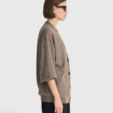 JONES + CO hazelnut cashmere-silk cardigan with drop shoulders and V-neckline worn by a woman in profile view
