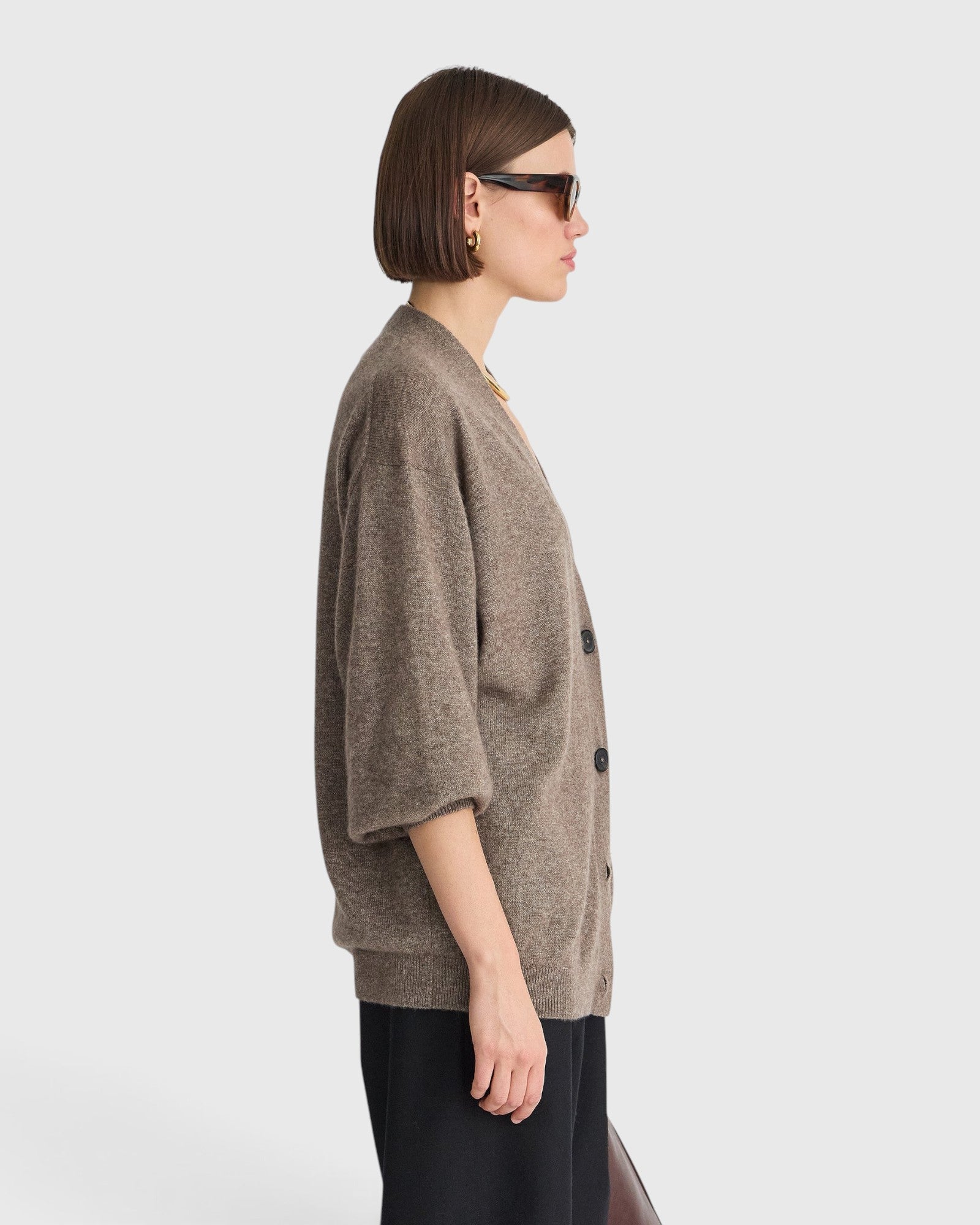 JONES + CO hazelnut cashmere-silk cardigan with drop shoulders and V-neckline worn by a woman in profile view