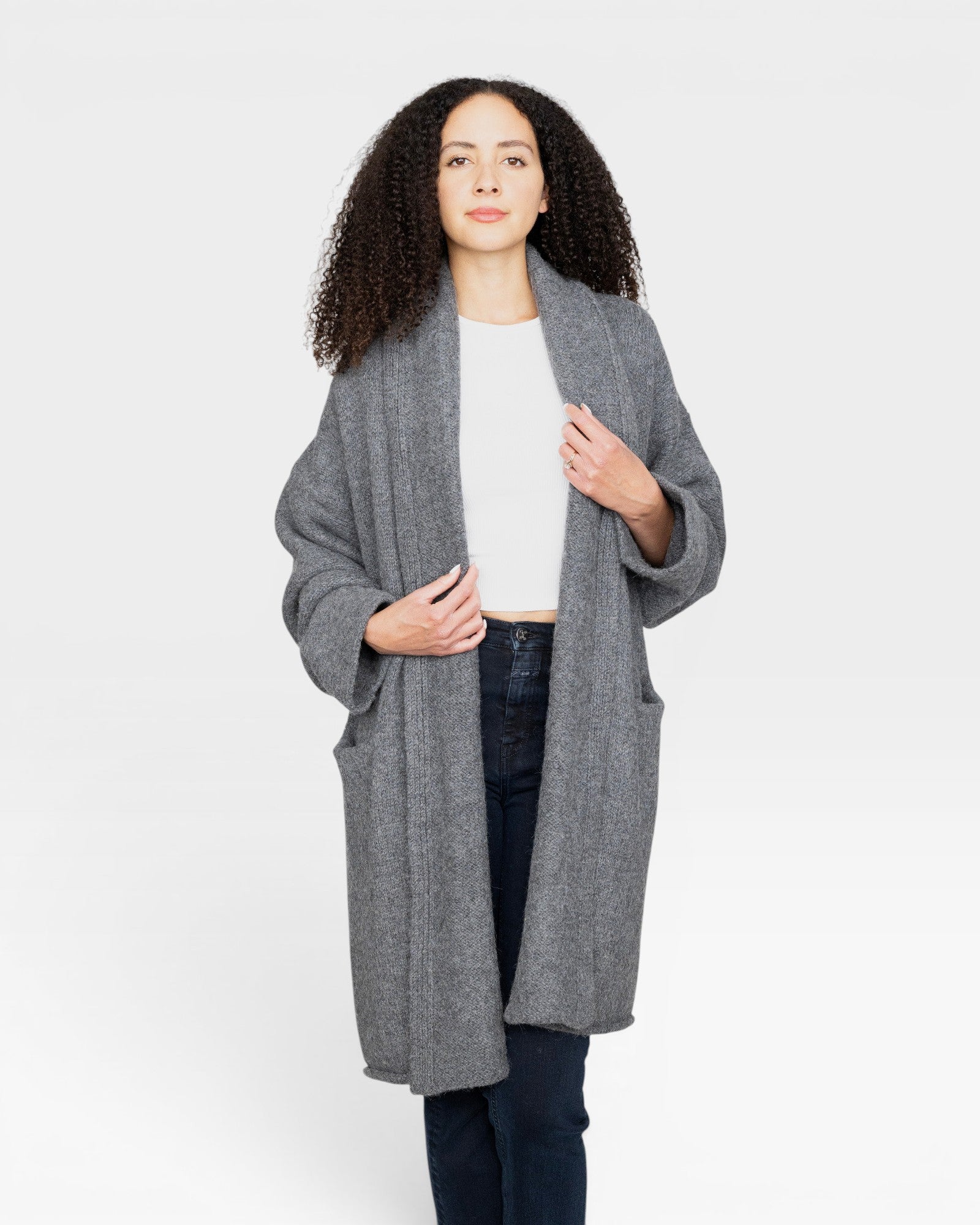 Model wearing a JONES + CO heather grey baby alpaca sweater coat with dropped shoulders and front pockets.