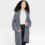 Model wearing a JONES + CO heather grey baby alpaca sweater coat with dropped shoulders and front pockets