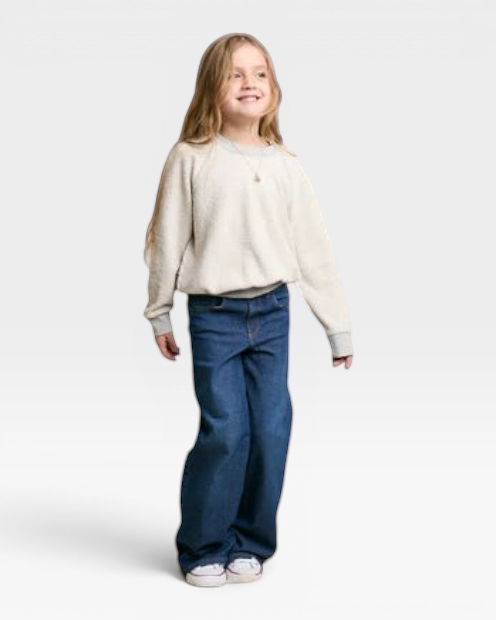 JONES + CO child wearing a heather grey soft cotton fleece Mini Ziggy sweatshirt with an inside-out heritage look.