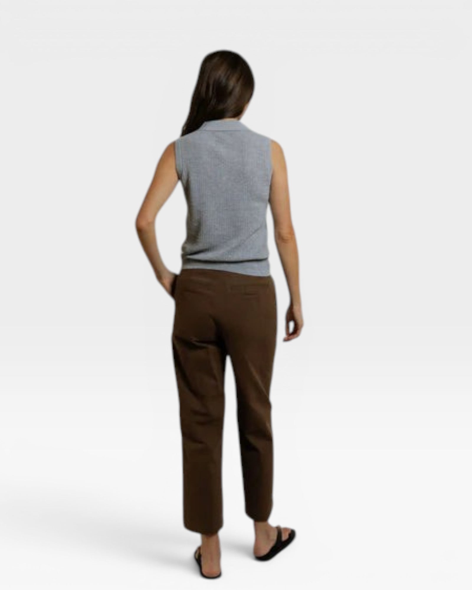 JONES + CO heather grey sleeveless pointelle knit polo tank with ribbed hem worn by a woman.