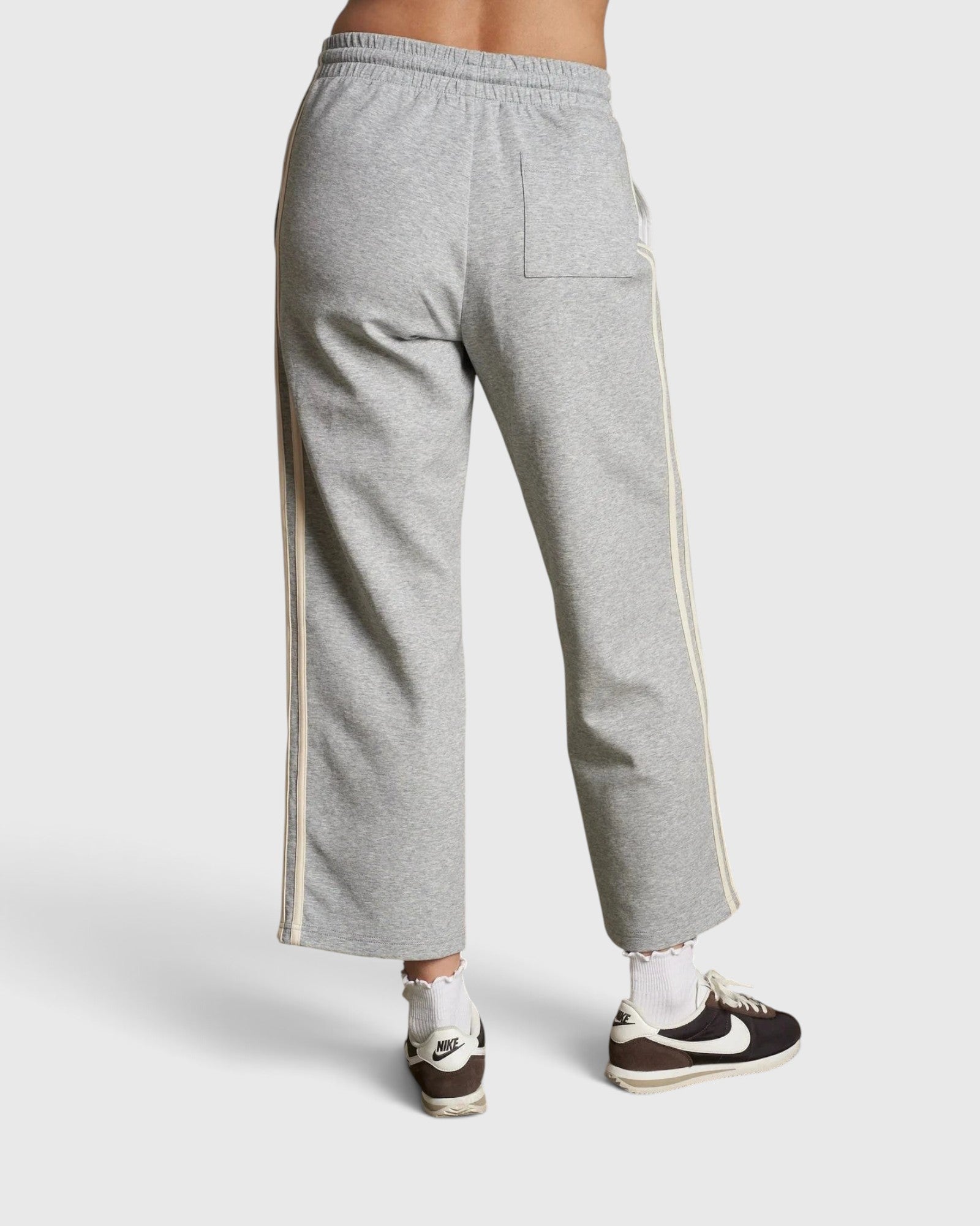 JONES + CO Claud travel track pants in heather grey cotton fleece with ivory side stripe detail, back view.
