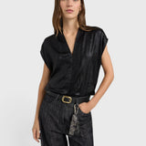JONES + CO Hildra black sleeveless blouse in fluid laminated fabric with a V-neck and shawl collar on a model.