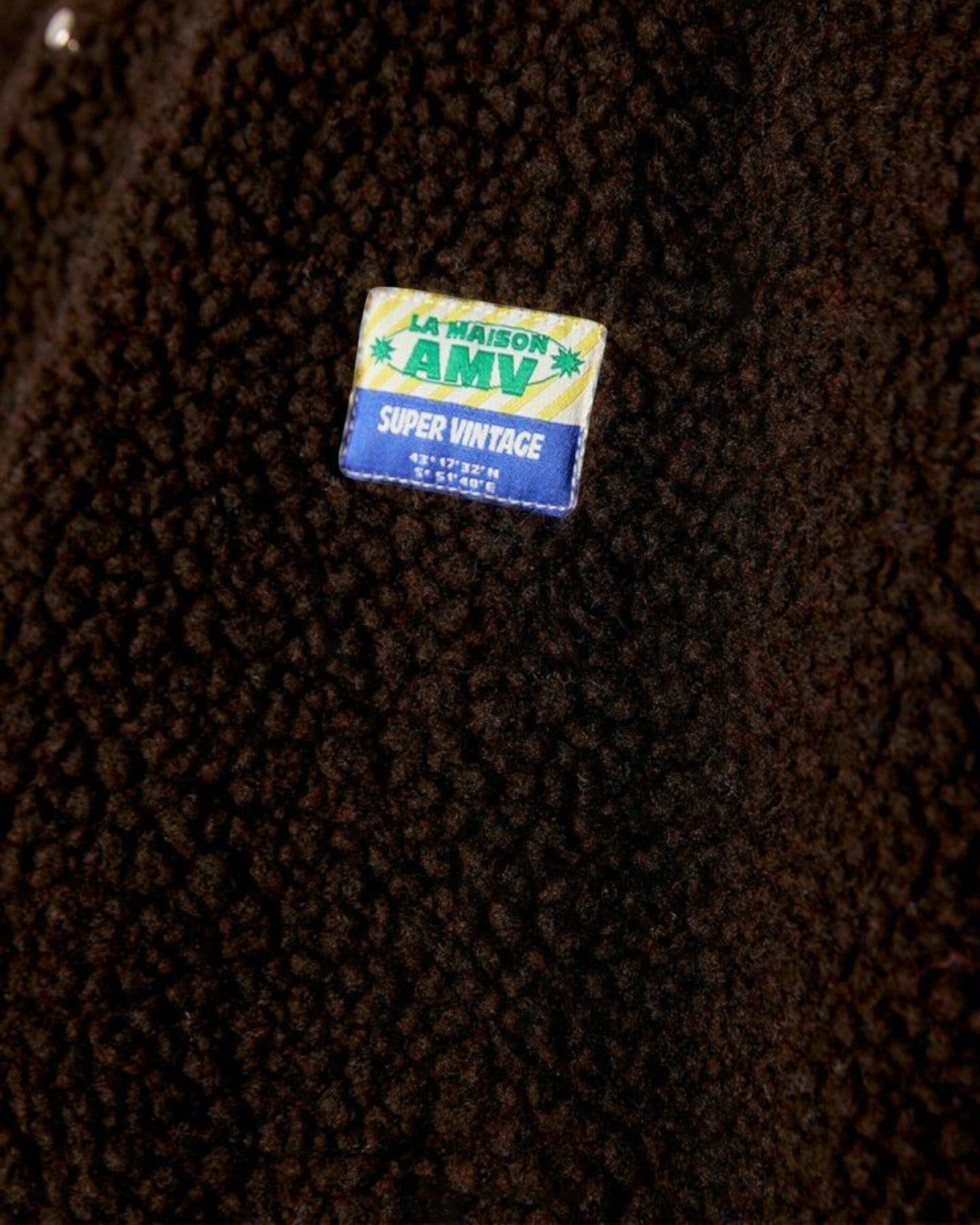JONES + CO Hoktown sleeveless jacket in chestnut brown shearling fabric with a branded patch detail