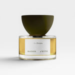 JONES + CO I-Dream Eau de Parfum in a clear glass bottle with a dark olive green cap. The golden liquid is visible.