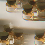 JONES + CO I—Dream Eau de Parfum in clear glass bottles with dark caps, featuring a golden liquid.