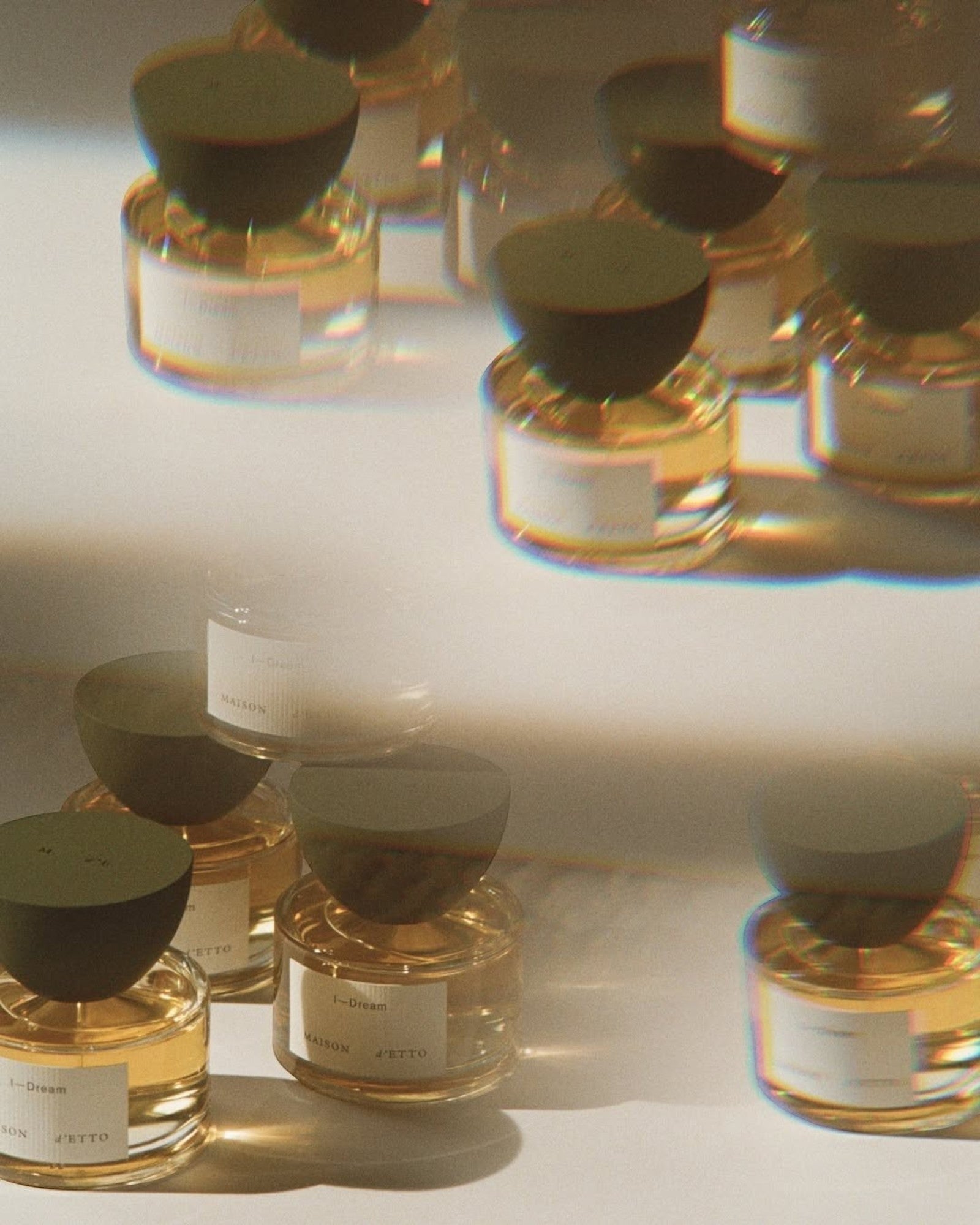JONES + CO I—Dream Eau de Parfum in clear glass bottles with dark caps, featuring a golden liquid.
