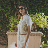 JONES + CO white linen shorts with elastic waistband, paired with a matching short-sleeve button-up shirt.