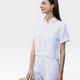 JONES + CO white linen shorts with drawstring waist and matching short-sleeve button-up shirt.