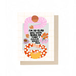 JONES + CO I'm So Glad birthday card featuring an illustrated couple at a table with flowers and a coffee mug.