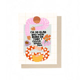 JONES + CO I'm So Glad birthday card featuring an illustrated couple at a table with flowers and a coffee mug.