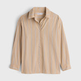 JONES + CO  apiece apart Isolde button-down shirt in sand with blue vertical stripes, featuring a structured collar and loose fit.
