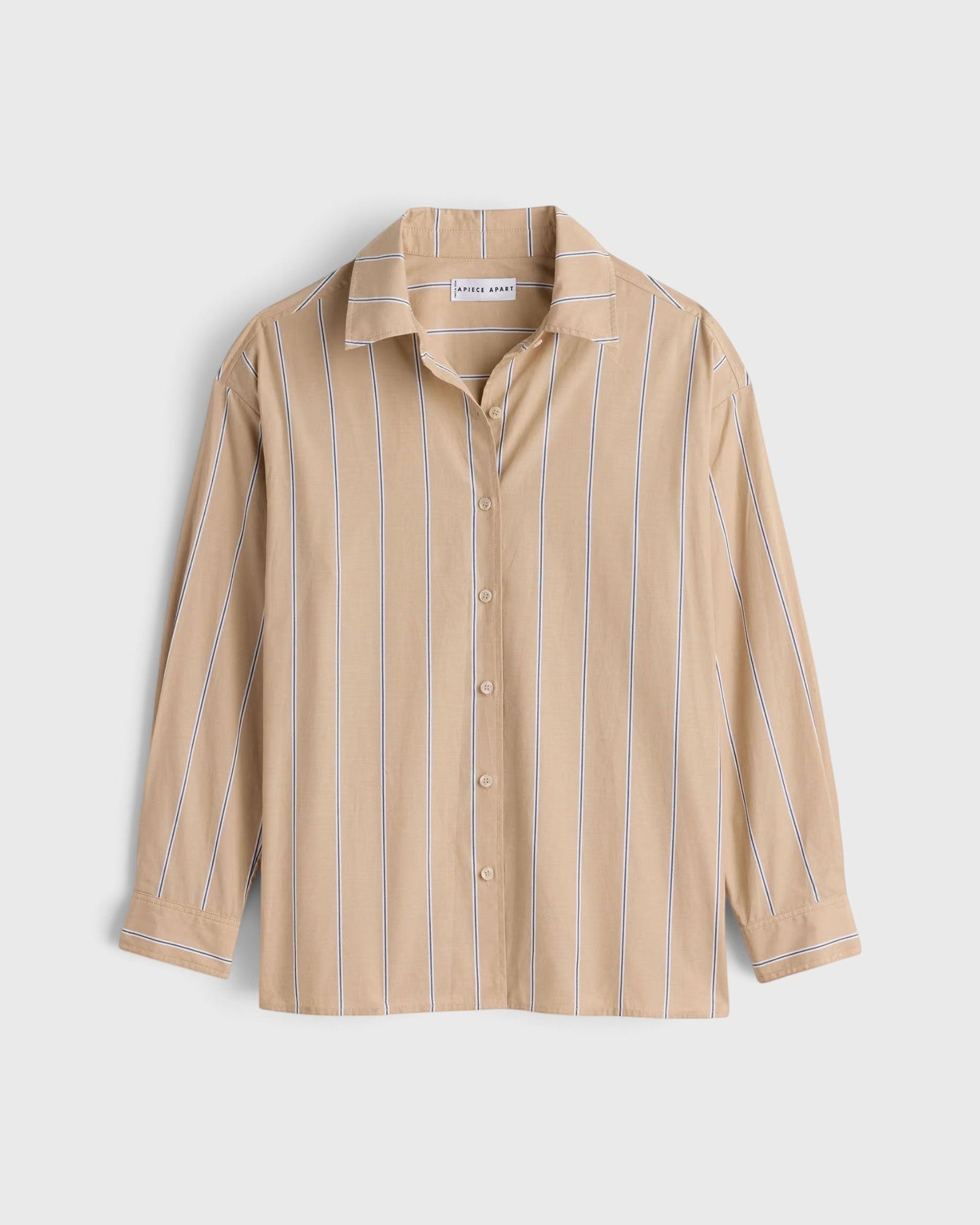 JONES + CO  apiece apart Isolde button-down shirt in sand with blue vertical stripes, featuring a structured collar and loose fit.