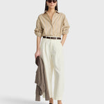 JONES + CO  apiece apart Isolde button down shirt in sand and blue stripe with dropped shoulders and oversized fit on a model
