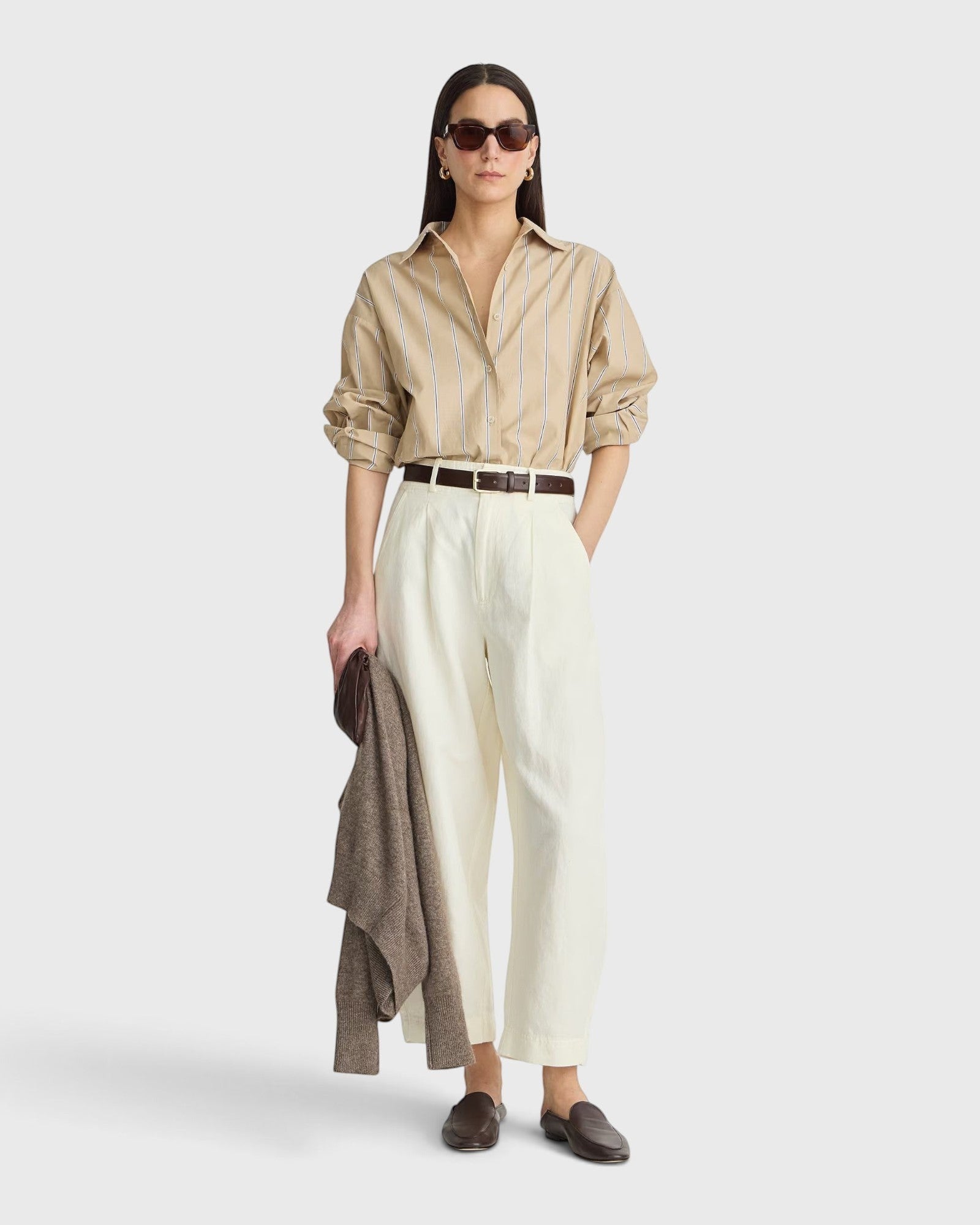 JONES + CO  apiece apart Isolde button down shirt in sand and blue stripe with dropped shoulders and oversized fit on a model