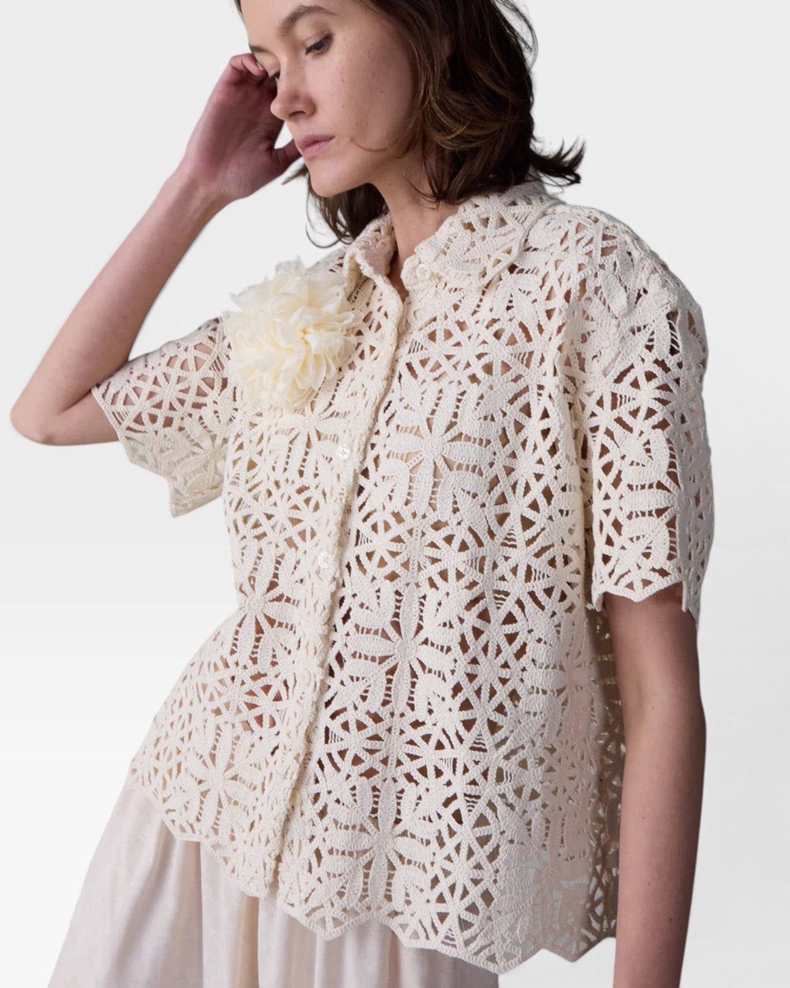 JONES + CO ivory cotton lace short sleeve oversized button-down shirt with floral pattern and detachable flower accent.