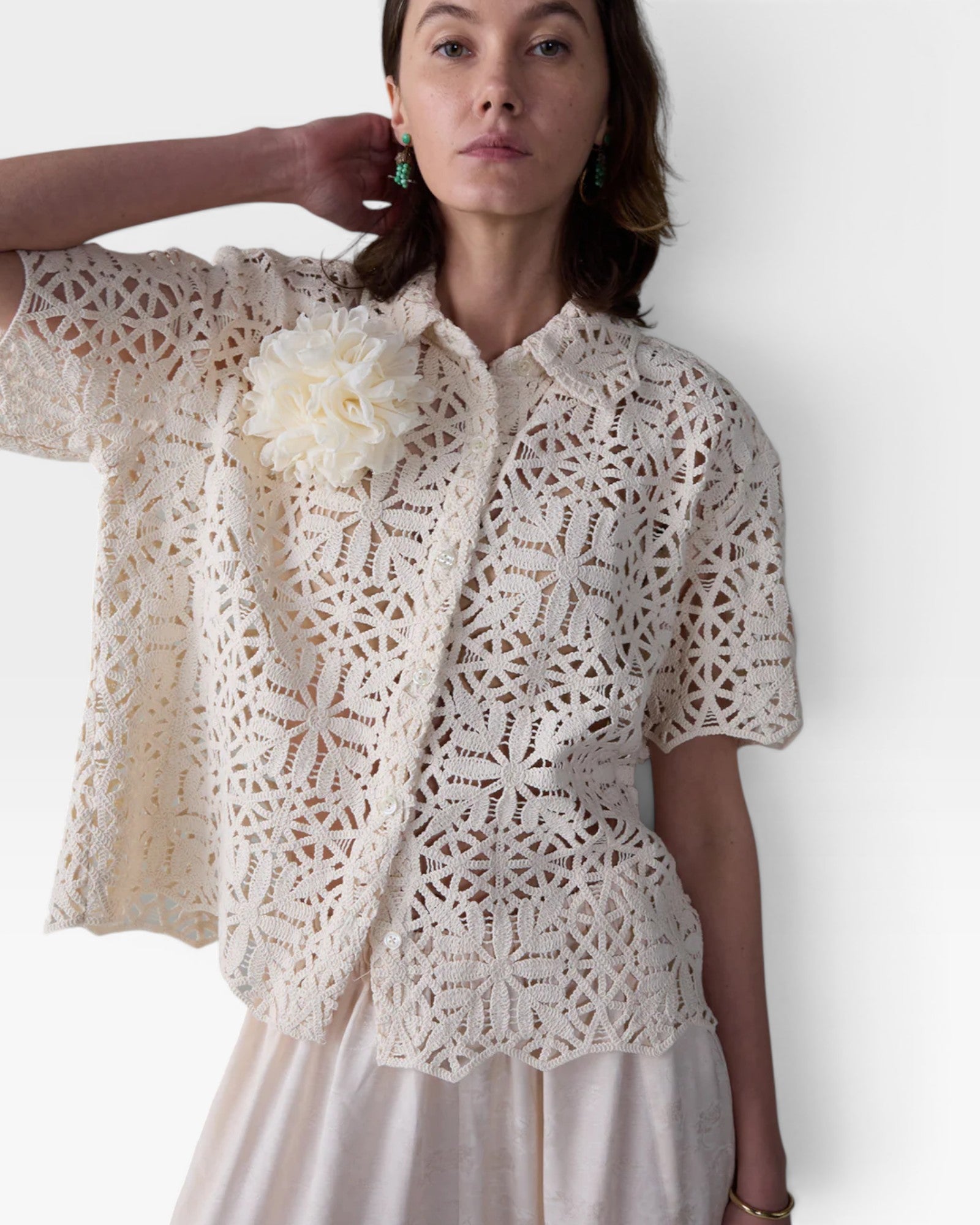 JONES + CO ivory cotton lace short sleeve oversized button-down shirt with floral crochet and detachable flower accent.