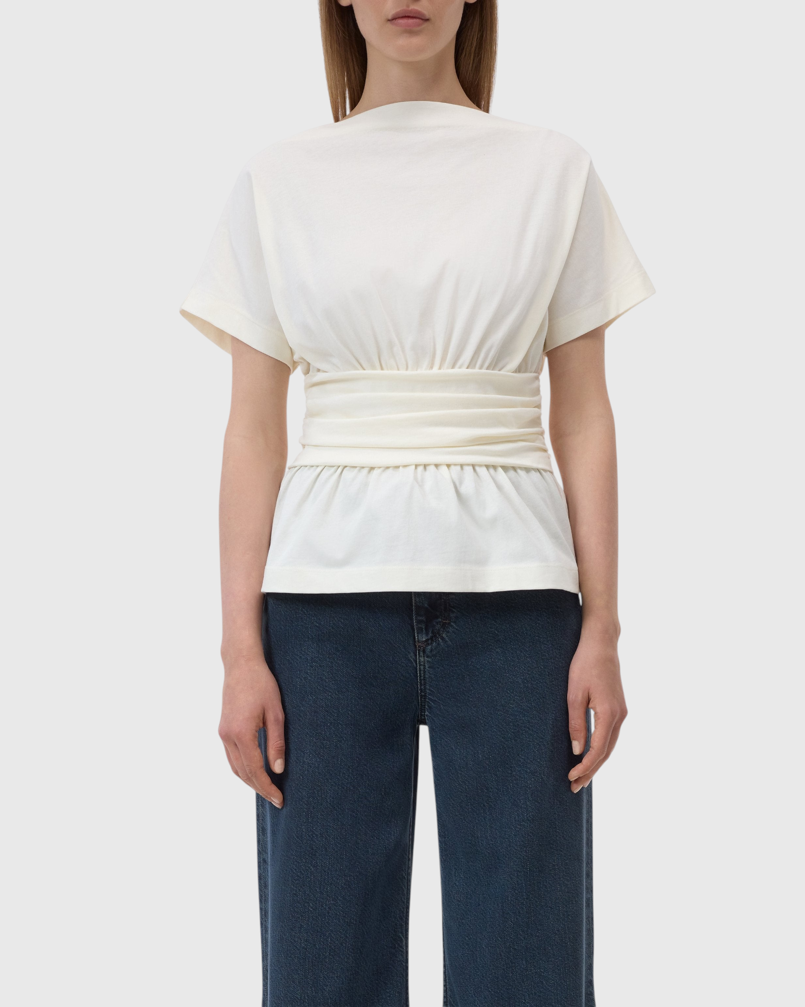 JONES + CO ivory organic cotton jersey T-shirt with a draped waist effect and straight neckline worn by a model.
