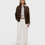 Model wearing JONES + CO ivory Jayla jeans in rigid denim with a wide-leg silhouette and mid-rise waist