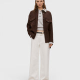 Model wearing JONES + CO ivory Jayla jeans in rigid denim with a wide-leg silhouette and mid-rise waist