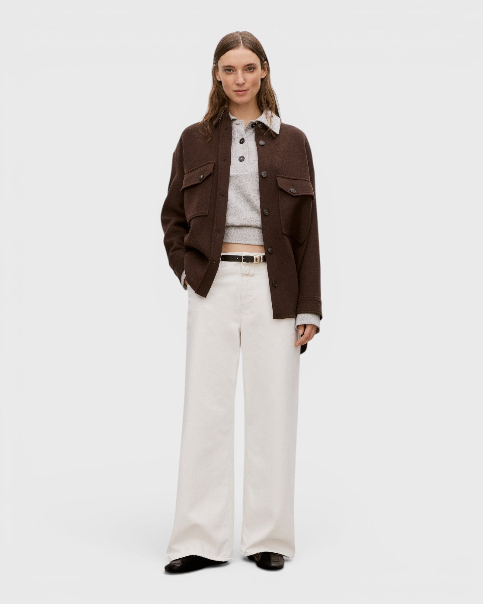 Model wearing JONES + CO ivory Jayla jeans in rigid denim with a wide-leg silhouette and mid-rise waist