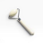 JONES + CO jade roller with a cream-colored stone and handle, designed to depuff and improve circulation.