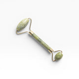 JONES + CO jade roller for depuffing and improving circulation. Features a green jade stone and gold-tone metal.