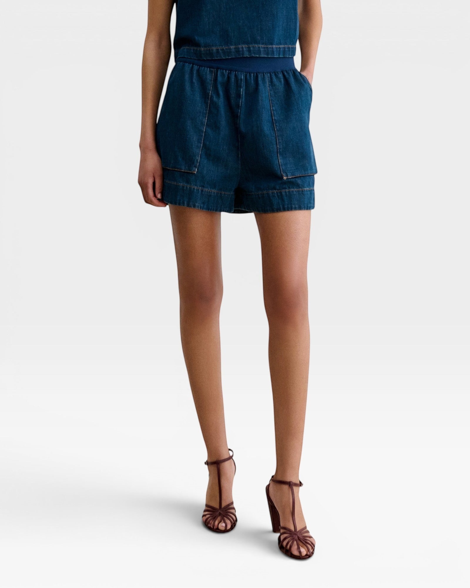 JONES + CO Jalen shorts in muddy indigo denim with elastic waist and two front patch pockets.