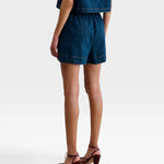 JONES + CO Jalen shorts in muddy indigo denim with elastic waist and patch pockets. Relaxed fit.
