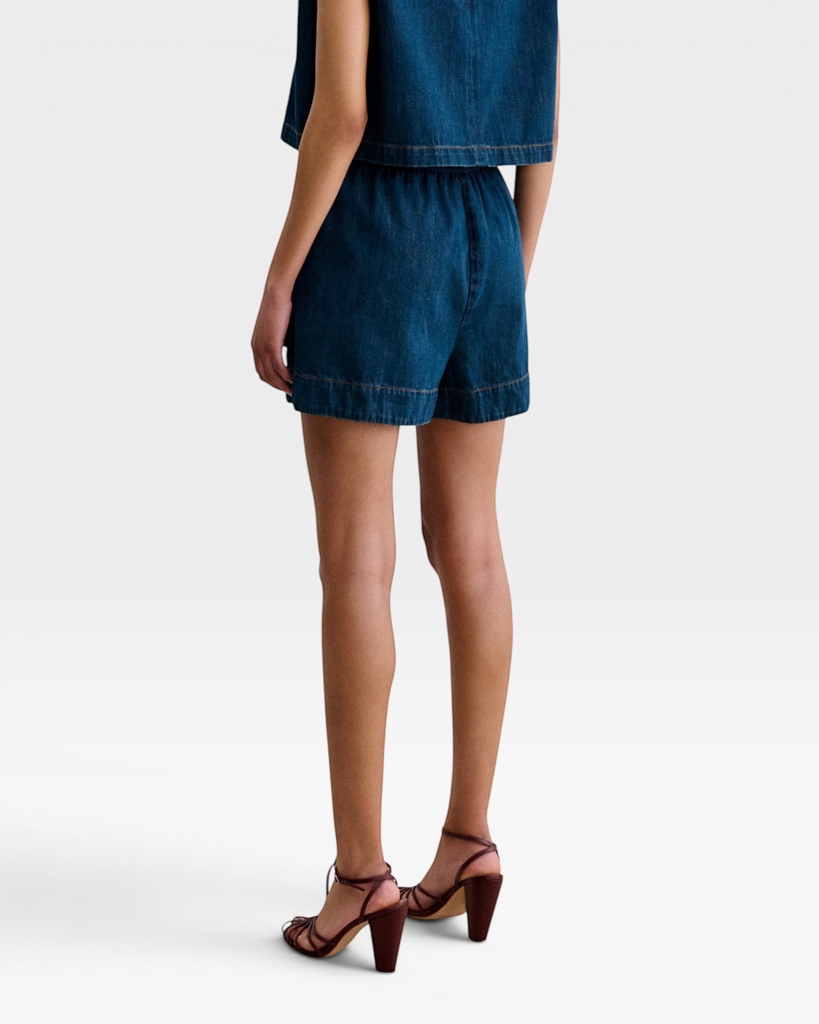 JONES + CO Jalen shorts in muddy indigo denim with elastic waist and patch pockets. Relaxed fit.
