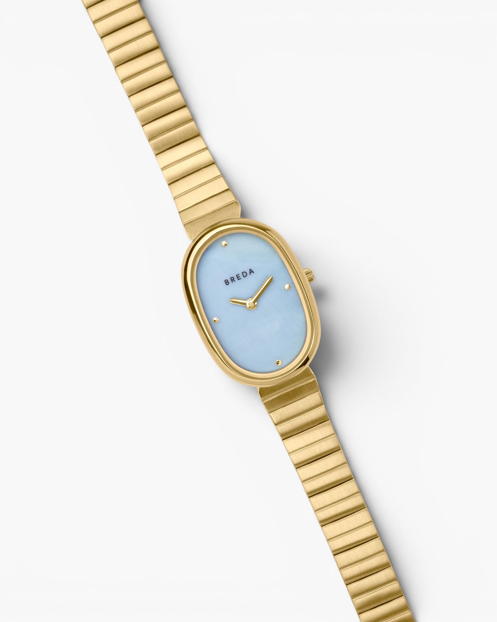 JONES + CO Jane watch with a 23mm oval gold case, sky blue mother-of-pearl dial, and gold-plated link bracelet.