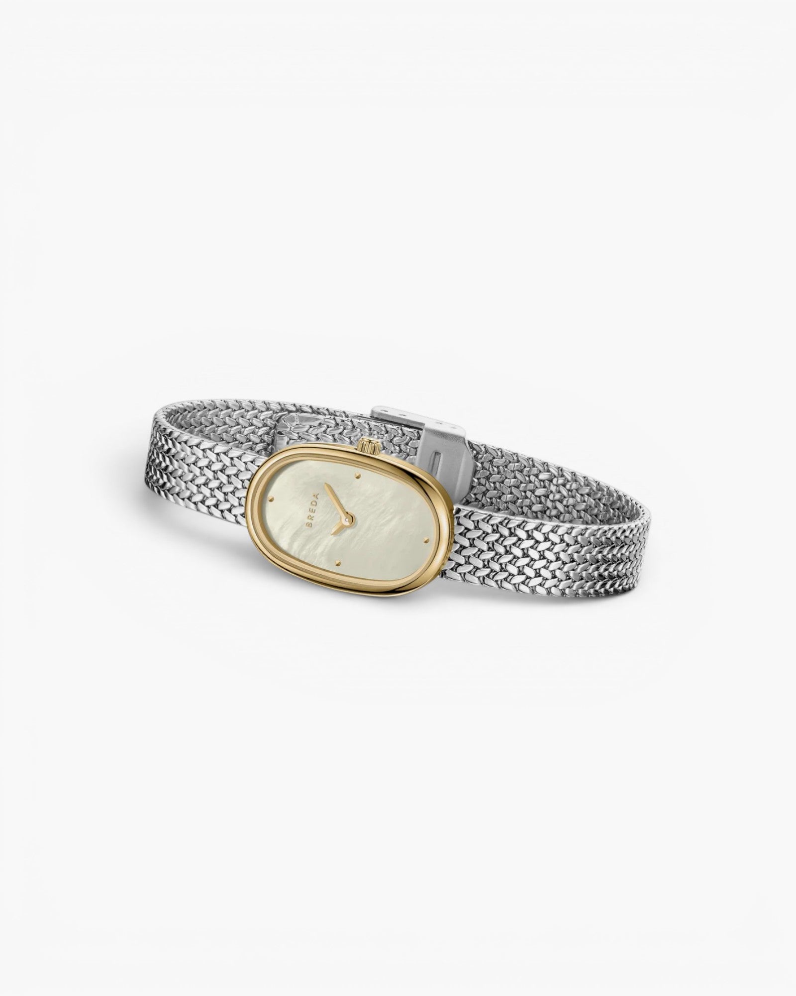 JONES + CO Jane Small Tethered watch with gold oval case, champagne mother of pearl dial, and silver mesh bracelet.