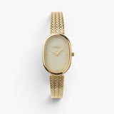 JONES + CO Jane Tethered watch with a gold oval case, champagne mother-of-pearl dial, and woven mesh bracelet.