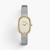 JONES + CO Jane Tethered watch featuring a 23mm oval case, champagne mother of pearl dial, and silver woven mesh strap.