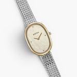 JONES + CO Jane Tethered watch with a 23mm oval case, champagne mother of pearl dial, and silver woven mesh bracelet.