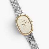 JONES + CO Jane Tethered watch with a 23mm oval case, champagne mother of pearl dial, and silver woven mesh bracelet.